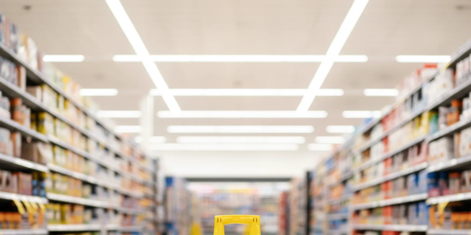 A yellow wet-floor caution sign on a tiled floor in a bright Miami store — Accident Lawyer Miami Plus